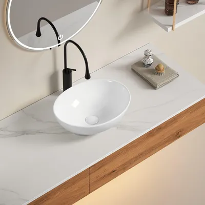Immagine prodotto di Lavabo da appoggio ovale in Vetroceramica bianca per rubinetteria a parete