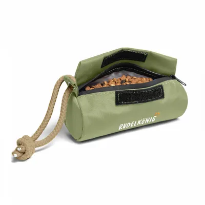 A green dog treat pouch filled with kibble, shown on a white background.
