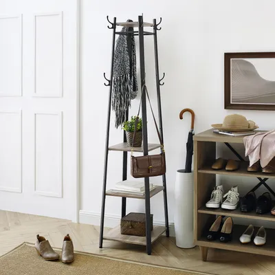 An entryway scene with a coat rack, shoe rack, and accessories.
