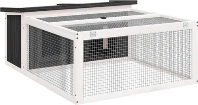 A white and black wooden rabbit hutch with a wire mesh front and top.