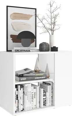 A white cube shelf unit displaying decorative items and books.