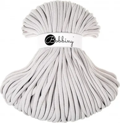 A ball of thick, light gray cord is displayed against a white background. A white label with the brand name 'Bobbiny' is wrapped around the top of the ball.