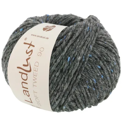 A ball of grey tweed yarn with blue flecks, featuring a label with brand and product information.