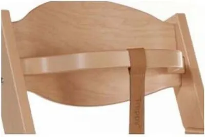 Close-up of a wooden high chair strap and backrest.