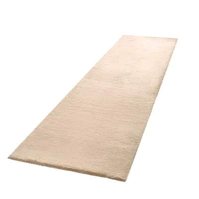 A beige rug is shown from a diagonal angle against a white background.