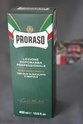 A green box of Proraso aftershave lotion is shown against a gray background.