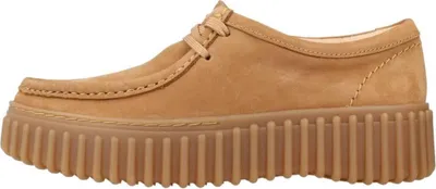 A side view of a brown Clarks Torhill Bee shoe with a thick, ribbed sole.