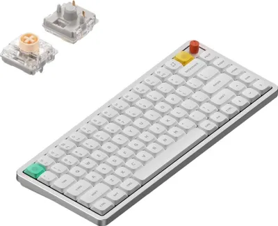 A white Nuphy Air75 V3 mechanical keyboard is shown from a slightly elevated diagonal angle, with two mechanical keyboard switches placed in the upper left corner.