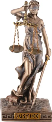 A statue of the Roman goddess of justice, Justitia, holding scales and a sword, standing on a book and a snake.