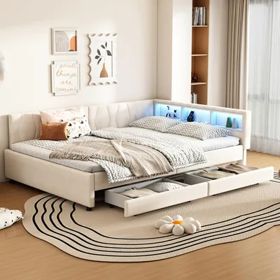 A bedroom scene featuring a beige daybed with LED lighting and storage drawers, decorated with pillows and a blanket.
