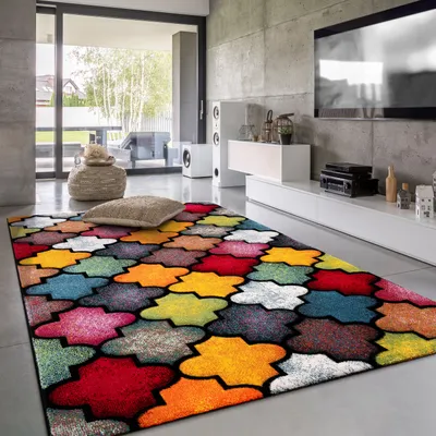 A modern living room with a large, colorful geometric rug in the foreground.