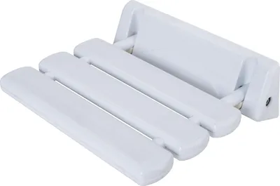 A white folding shower seat mounted on a wall.