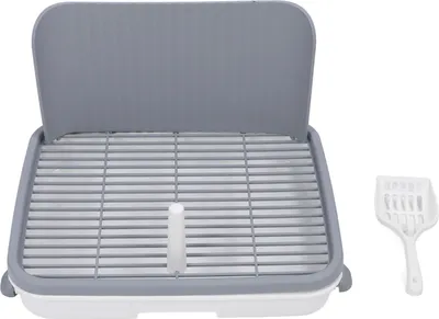 A pet toilet training tray with a scoop.