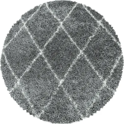 A round, shaggy rug with a diamond pattern.