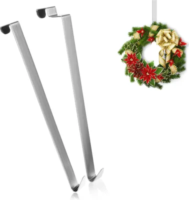 Two silver door hooks and a Christmas wreath.