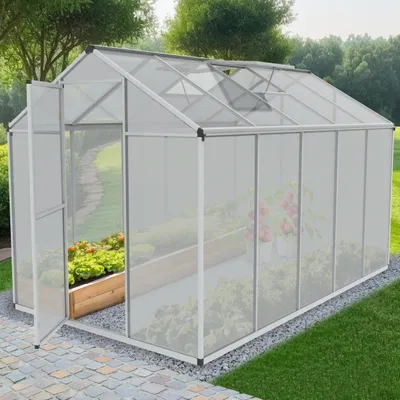 A greenhouse with plants inside, set in a garden environment.