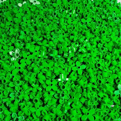 A pile of small green LEGO flower pieces.