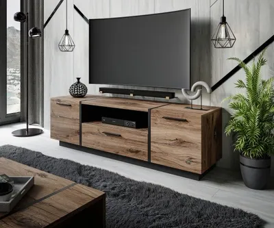 A modern living room with a TV stand, TV, and decor.