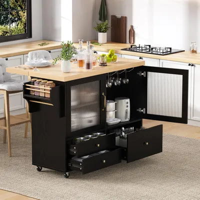 A kitchen island cart with a wooden countertop, black base, glass doors, and drawers, set in a kitchen environment with a window and stovetop visible.