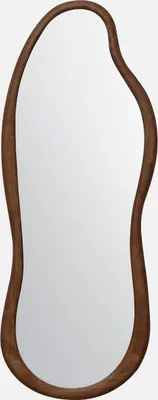 A mirror with an organic shape and a wooden frame.