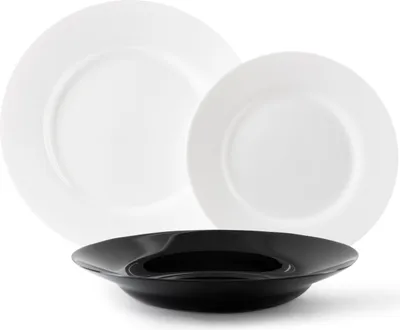 Three plates are arranged in a studio shot against a white background. Two white plates are stacked behind a black plate.