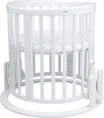 A white wooden rocking cradle for a baby.