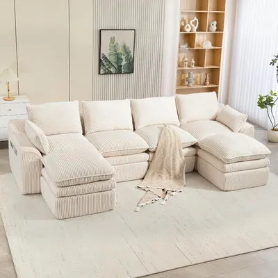 Zdjęcie produktu dla Modułowa sofa tapicerowana tkaniną Cord w kolorze beżowym, dwuosobowa, z dwoma podnóżkami, poduszkami i kieszeniami bocznymi, o wymiarach 335x167x85 cm. Sofa o dowolnej konfiguracji, idealna do salonu i biura