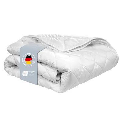 A folded white duvet with a label showing the German flag and OEKO-TEX certification.