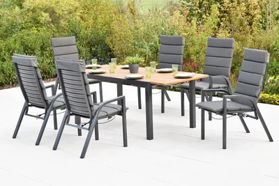 An outdoor dining set with a table and chairs on a patio.