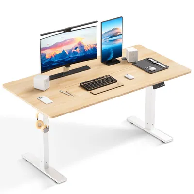 A modern, height-adjustable desk with dual monitors and accessories.