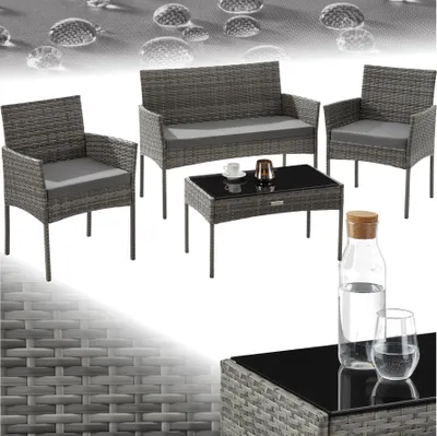 A rattan garden furniture set including a sofa, two chairs, and a coffee table, with water droplets on a textured background.