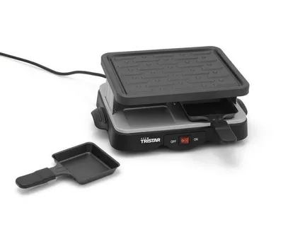 A raclette grill with a separate pan is shown on a white background.