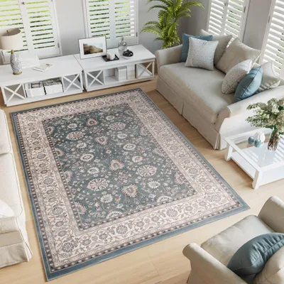 A living room scene with a rug, sofa, and coffee table.