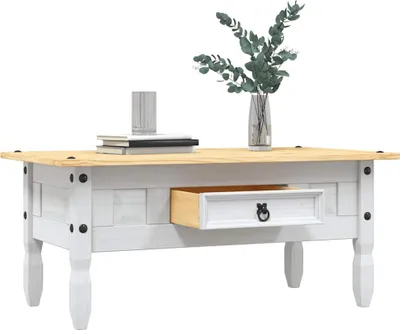 A white and wood coffee table with a drawer, a vase of greenery, and books on top, set against a white background.