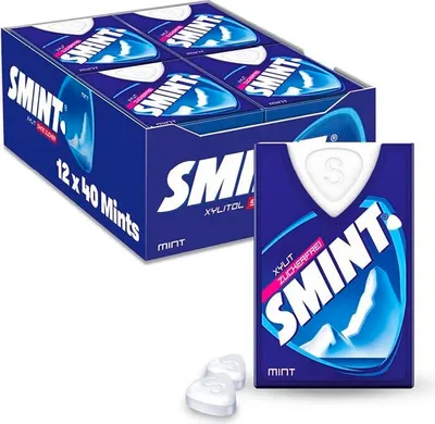A product shot showing a box of Smint mints and a single pack of Smint mints, along with two loose mints.