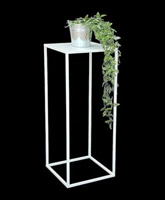 A white metal plant stand with a potted plant on top.