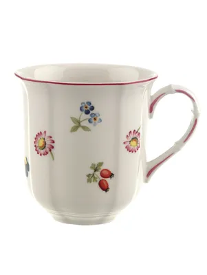 A white ceramic mug with a floral pattern and a red rim.