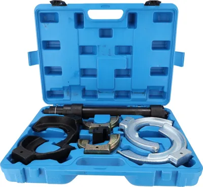 A tool kit for car suspension systems, laid out in its blue plastic case.