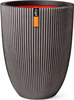 A dark grey ribbed planter with an orange interior, featuring a small orange label with black text.