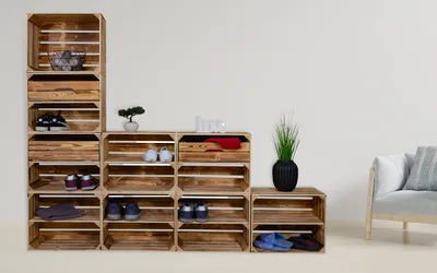 A modular shelving unit made of wooden crates, arranged to store shoes and other items.