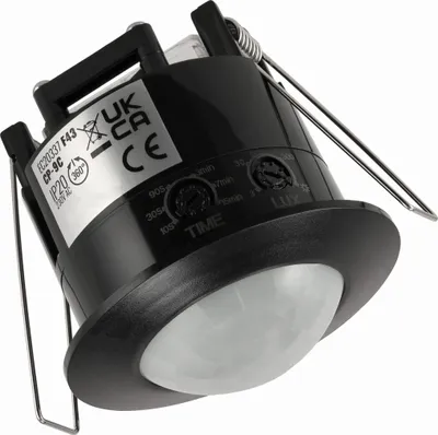 A close-up, angled view of a black ceiling-mounted motion sensor with adjustable dials.
