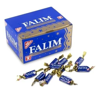 A box of Falim chewing gum with several pieces of gum scattered in front of it.