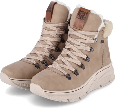 A pair of beige women's boots with white fur lining and beige laces, presented on a white background.
