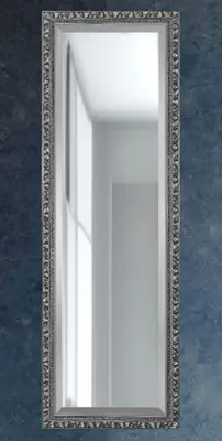 A tall, rectangular mirror with a decorative silver frame is shown against a dark blue textured background.