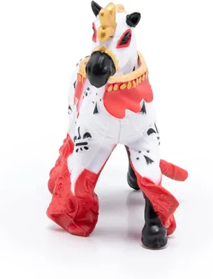 A toy horse with a decorative saddle and ornate patterns.