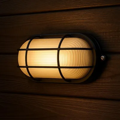 A close-up of an outdoor wall light mounted on a wooden wall.