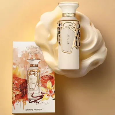 A perfume bottle and its packaging are displayed on a creamy, abstract background.