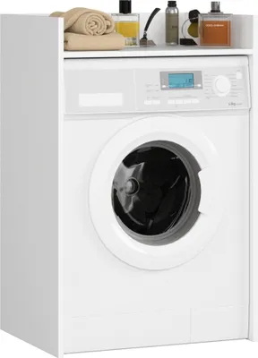 A white washing machine cabinet with a shelf on top holding towels and toiletries.