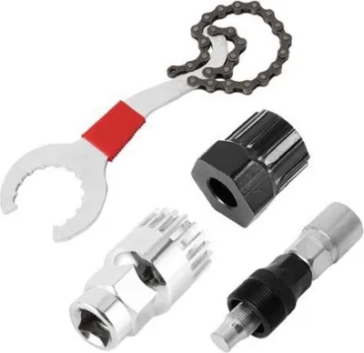 A set of bicycle repair tools, including a chain tool and various crank pullers, laid out on a white background.
