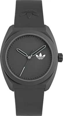A close-up studio shot of a dark gray Adidas watch.